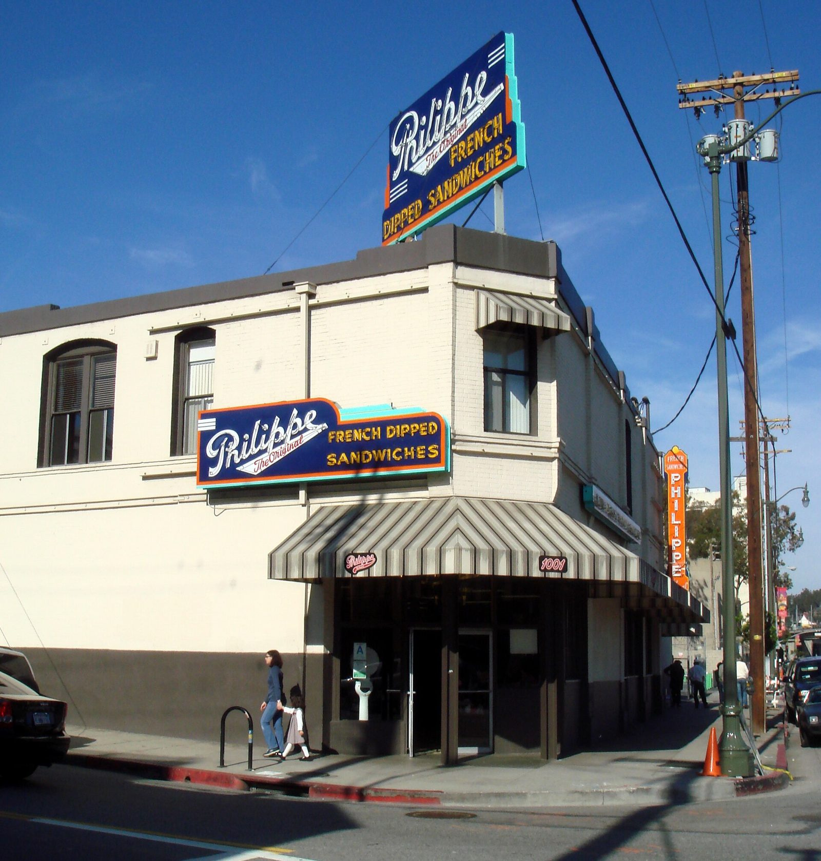 Philippe the Original's corner storefront with its neon French Dipped Sandwiches sign