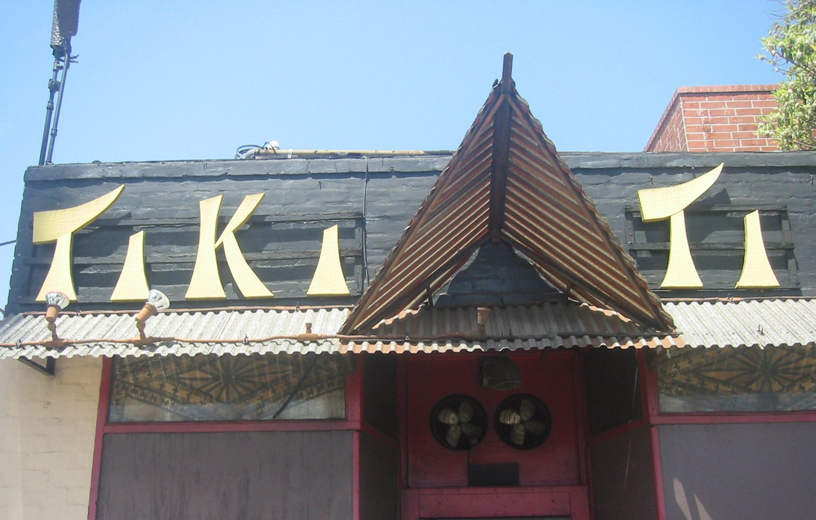The Tiki-Ti sign above the bar's small corrugated facade on Sunset Boulevard